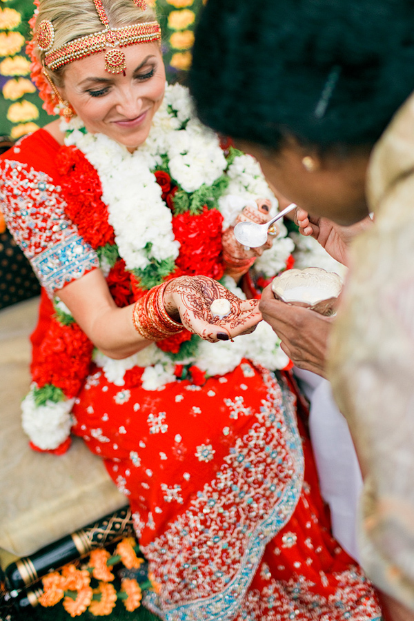 beautiful bride in bright red sari - traditional Indian wedding ceremony - photo by Chicago based wedding photographers Harrison Studio